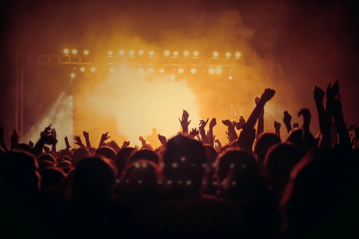 Crowd with raised hands at a live concert in Malaysia